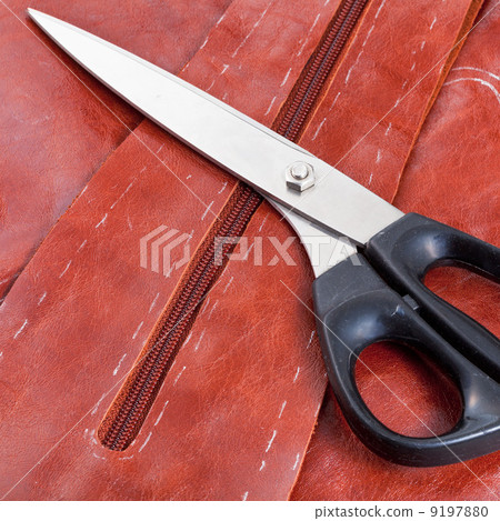 tailor shears and pattern on brown hide tailor shears and pattern on brown hide 9197880