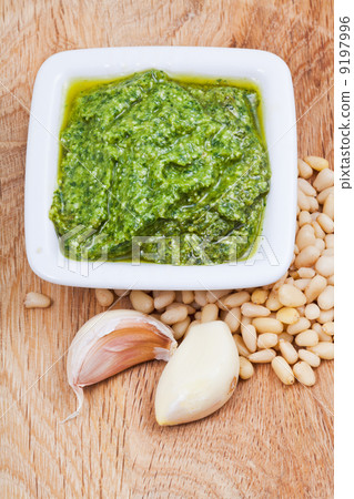italian pesto with nuts and garlic on wooden board italian pesto with nuts and garlic on wooden board 9197996