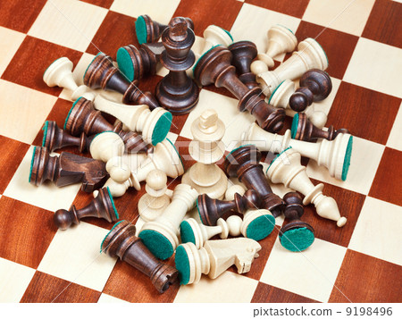 king in middle of spillage of chess pieces king in middle of spillage of chess pieces 9198496