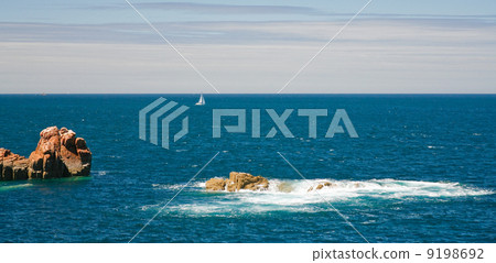 view on sea with pink rocks and yacht 9198692
