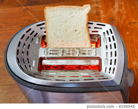 fresh slice of bread on hot metal toaster fresh slice of bread on hot metal toaster 9198948