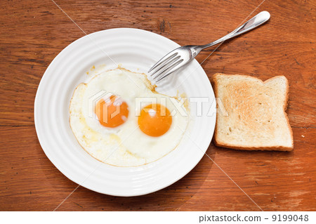 breakfast with two fried eggs in white plate breakfast with two fried eggs in white plate 9199048