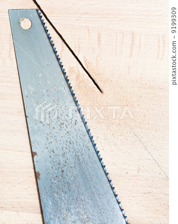 hacksaw at wooden board hacksaw at wooden board 9199309