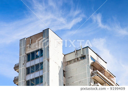 shabby municipal house under blue sky shabby municipal house under blue sky 9199409