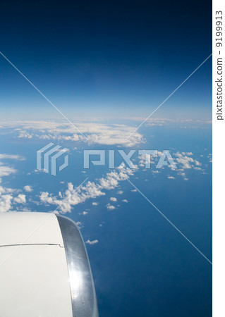 clouds under wing of airplane 9199913