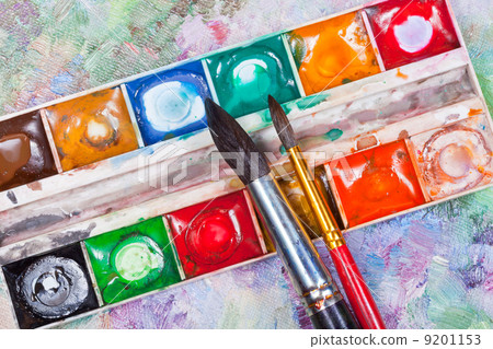 watercolor set and brushes on oil picture background 9201153
