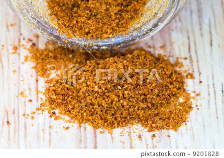cayenne pepper spilled from glass jar 9201828