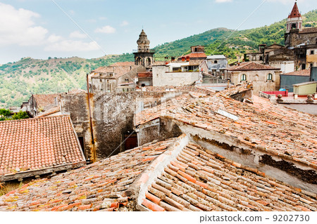 view on ancient tile roofs and church tower in sicilian town 9202730