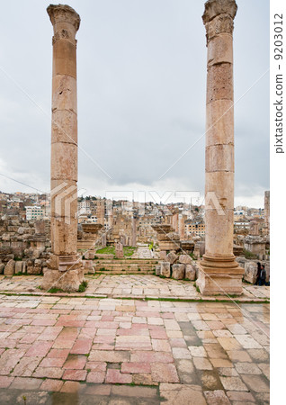 view through antique Artemis temple in ancient city Gerasa to modern Jerash 9203012