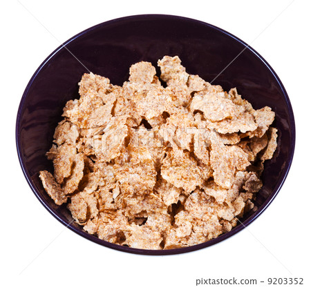 corn flakes in dark bowl corn flakes in dark bowl 9203352