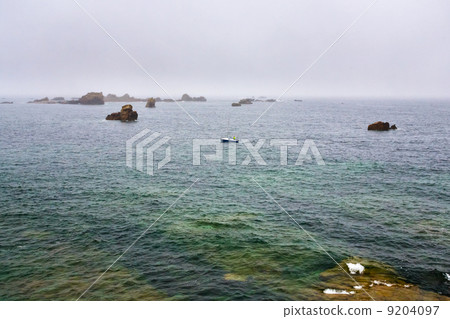 boat near stone coast of Brittany in rain boat near stone coast of Brittany in rain 9204097