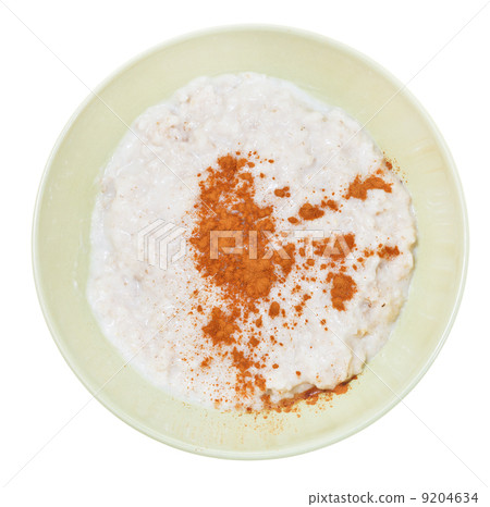 oat porridge with cinnamon in yellow bowl 9204634