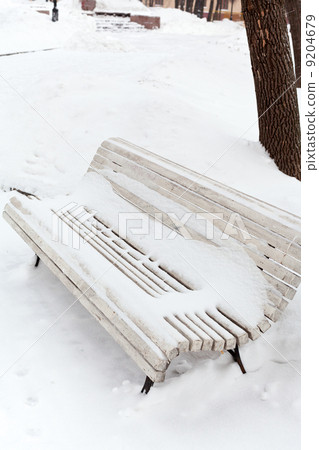 white snow-covered wooden bench white snow-covered wooden bench 9204679