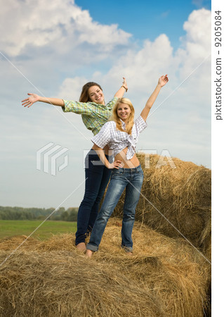 girls standing on hay 9205084