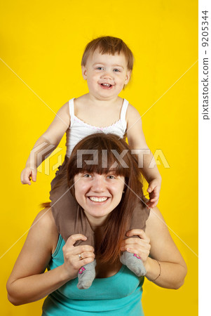 mother with child over yellow mother with child over yellow 9205344