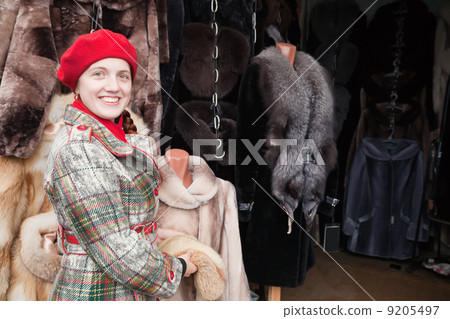 Woman chooses fur coat Woman chooses fur coat 9205497