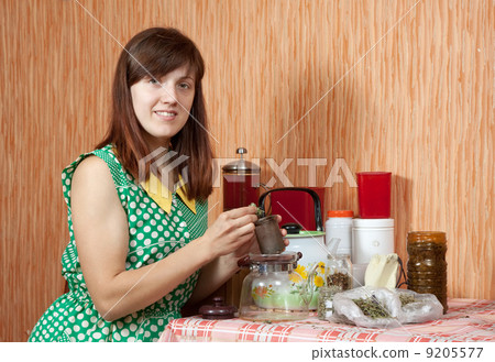 Woman brews herbs 9205577