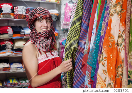 woman chooses egyptian shawl 9205701
