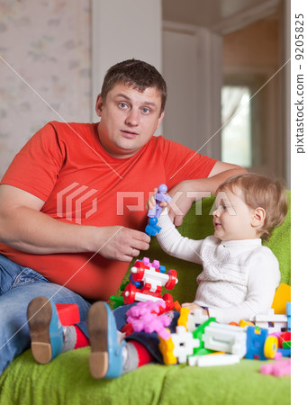 father and three-year child plays in home father and three-year child plays in home 9205825