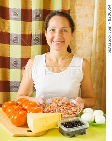 woman with ingredients for stuffed tomato woman with ingredients for stuffed tomato 9206054