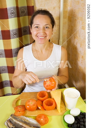 woman making stuffed tomato 9206082