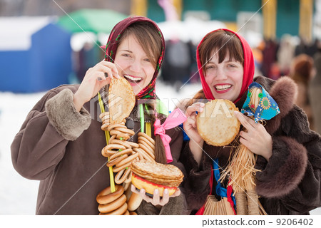Women tasting pancake during Shrovetide 9206402