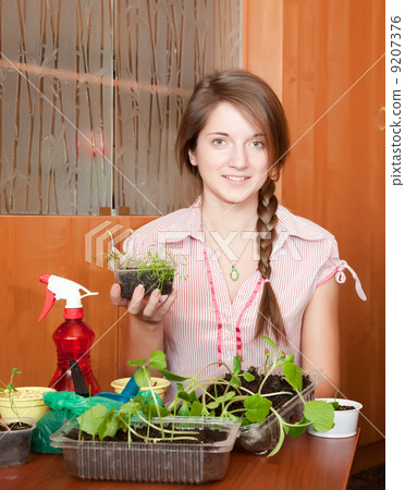 Girl with various seedlings at home Girl with various seedlings at home 9207376
