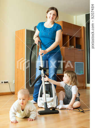 Happy mother wth two children cleans at home Happy mother wth two children cleans at home 9207484