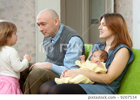 Happy couple with two their children 9207534