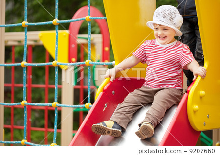 Happy two-year child on slide 9207660
