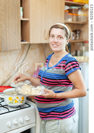 pregnant woman cooking dumplings pregnant woman cooking dumplings 9208123