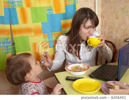 Mother and child eating breakfast Mother and child eating breakfast 9208401