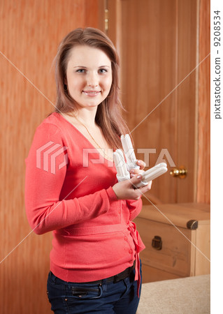 Girl holding energy light bulbs 9208534
