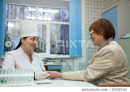 Nurse taking blood sample Nurse taking blood sample 9208592