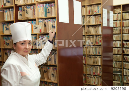 Nurse searching medical chart Nurse searching medical chart 9208598