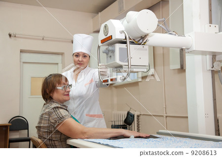doctor makes a hand x-ray of woman doctor makes a hand x-ray of woman 9208613