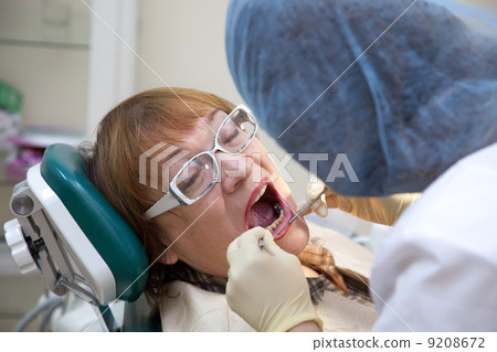 Dentist looking his patient Dentist looking his patient 9208672