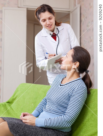 woman tells the doctor the symptoms of malaise woman tells the doctor the symptoms of malaise 9209240