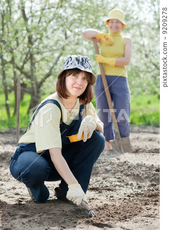 women works at garden in spring women works at garden in spring 9209278