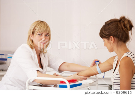 Nurse taking blood sample Nurse taking blood sample 9209615