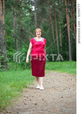 woman walking in pine forest 9209777