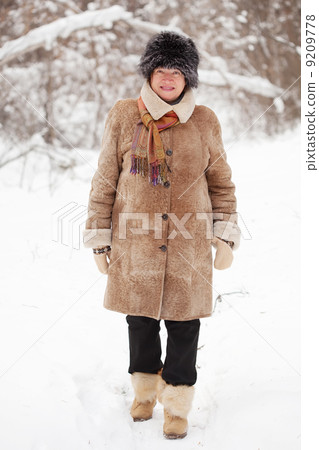 mature woman is walking at winter forest 9209778