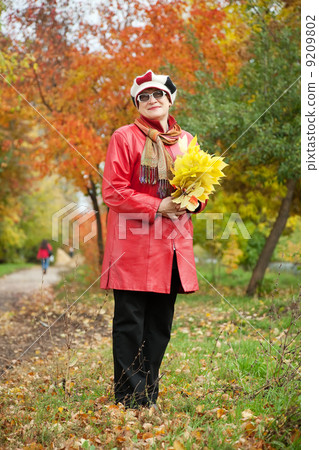 mature woman in autumn park mature woman in autumn park 9209802