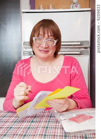 woman with utility bills at her home woman with utility bills at her home 9209833