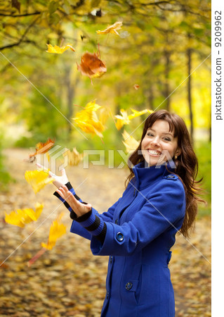 Girl throw up maple leaves 9209962