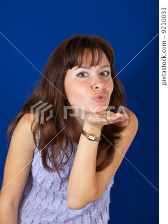 Air-kissing girl over blue Air-kissing girl over blue 9210031