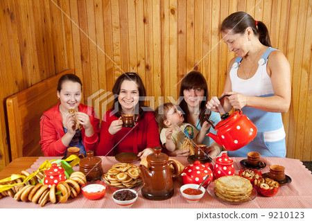 Women drinks tea with pancakes 9210123