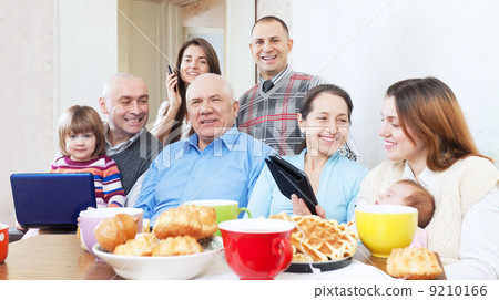 Happy family uses electronic devices 9210166