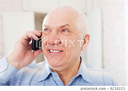 positive mature man speaks by phone 9210221