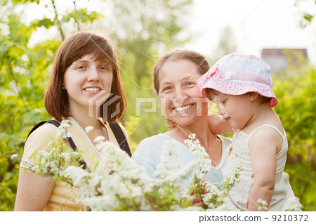 women and kid at summer garden women and kid at summer garden 9210372